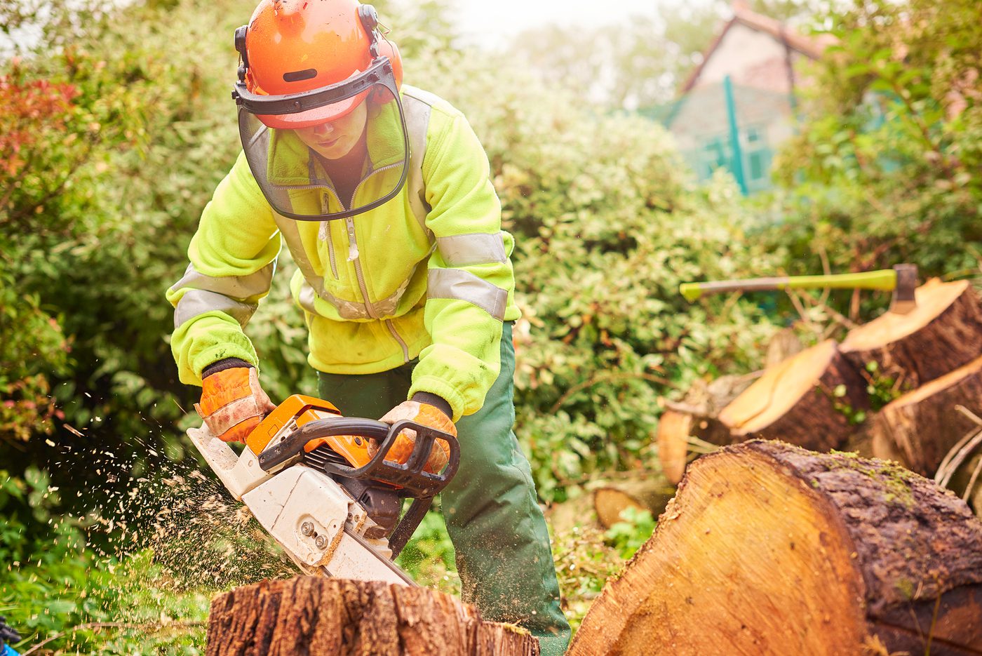 Person operating chainsaw